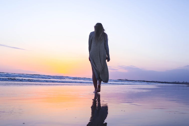 Woman with Menopause walking on the beach